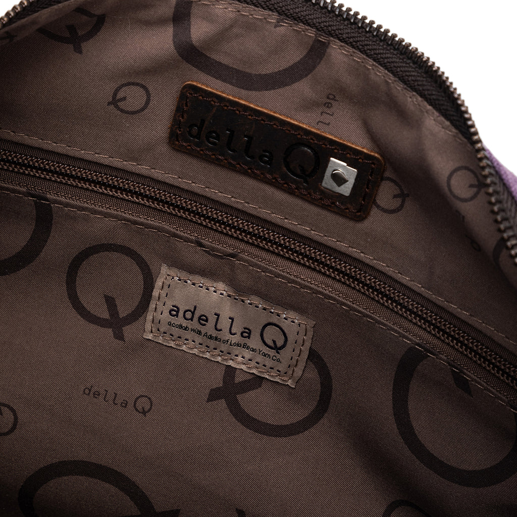 Close-up of the inside of the bag, showing the della Q logo and a special interior tag reading “adella Q - a collab with Adella of LolaBean Yarn Co.”